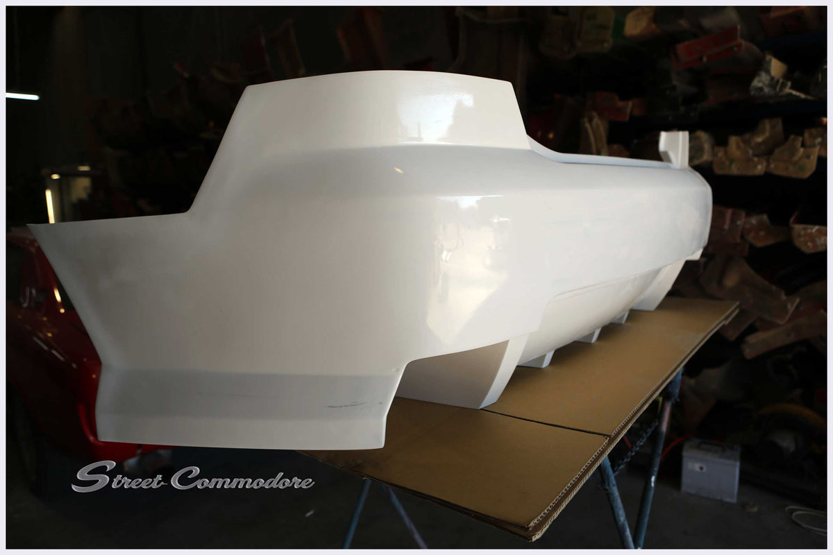 Super V8 rear bumper in raw white gel coat, left side profile